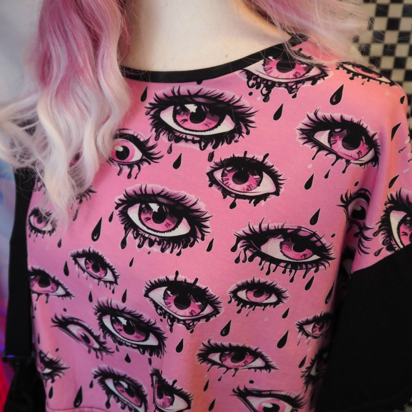 Mannequin wearing a pink crop top with eye pattern