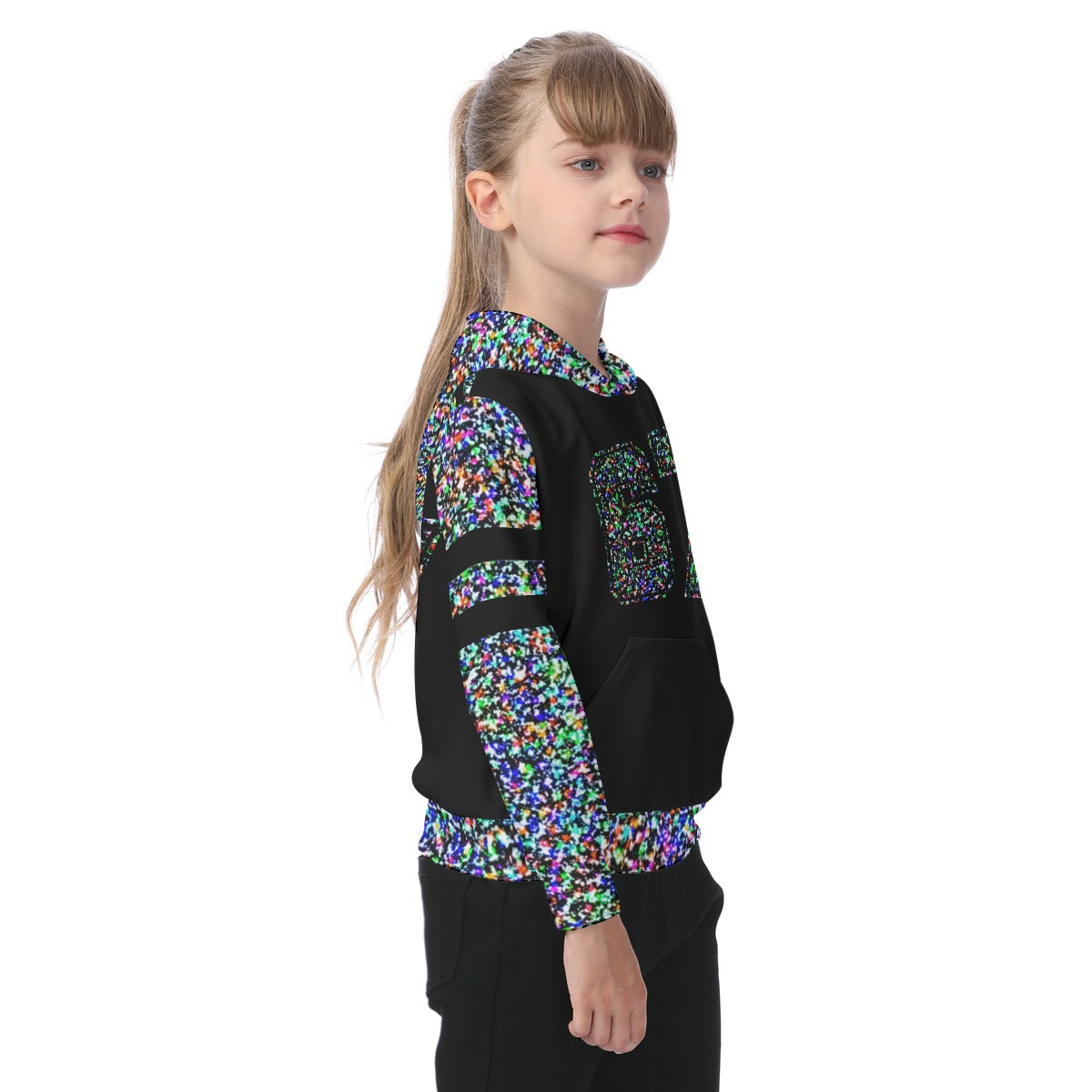 Young girl wearing a black and multicolored patterned outfit on a white background