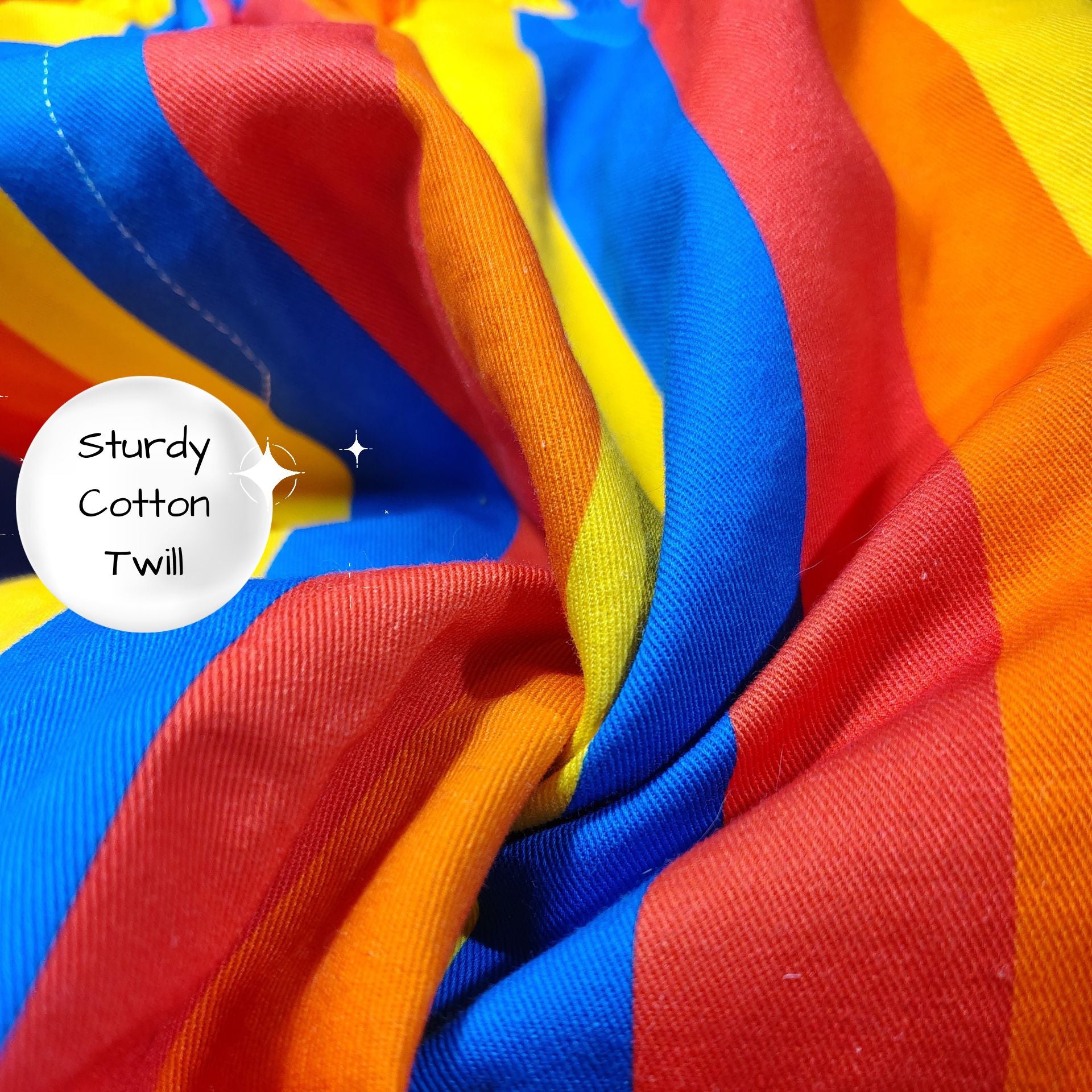 Close-up of colorful striped fabric with 'Sturdy Cotton Twill' label.