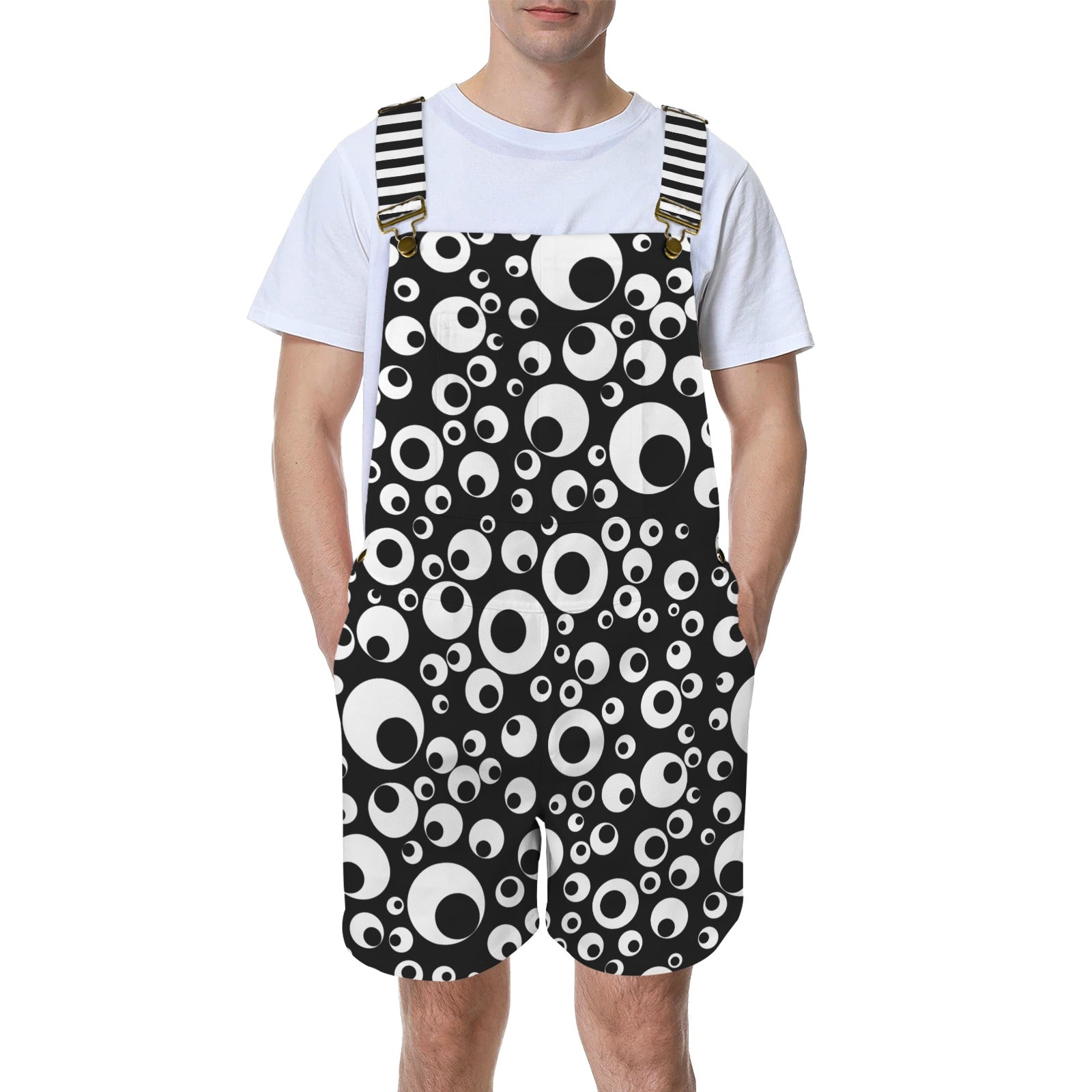 man wearing black and white googly eye print short overalls