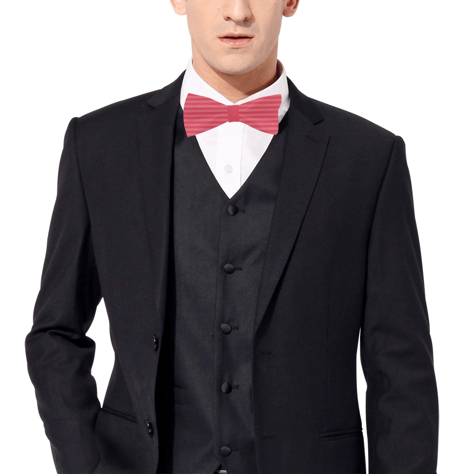 Man wearing a black suit with a red bow tie on a white background