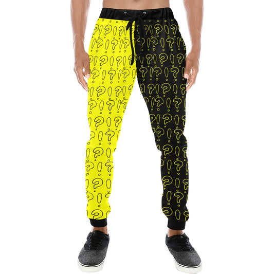 Black and yellow jogger pants with question mark pattern worn by a person on a white background