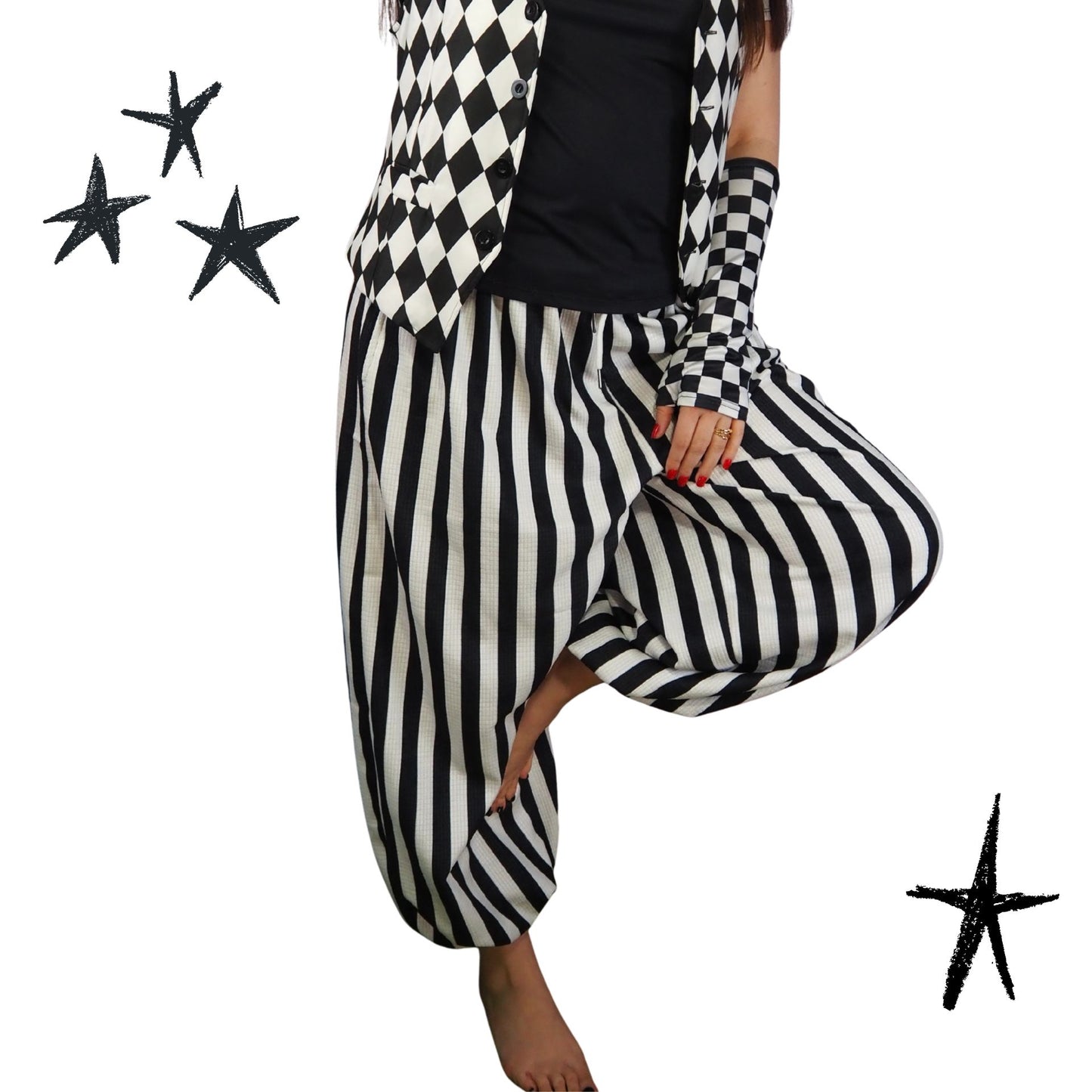 Person wearing a black and white checkered jacket and striped pants on a white background