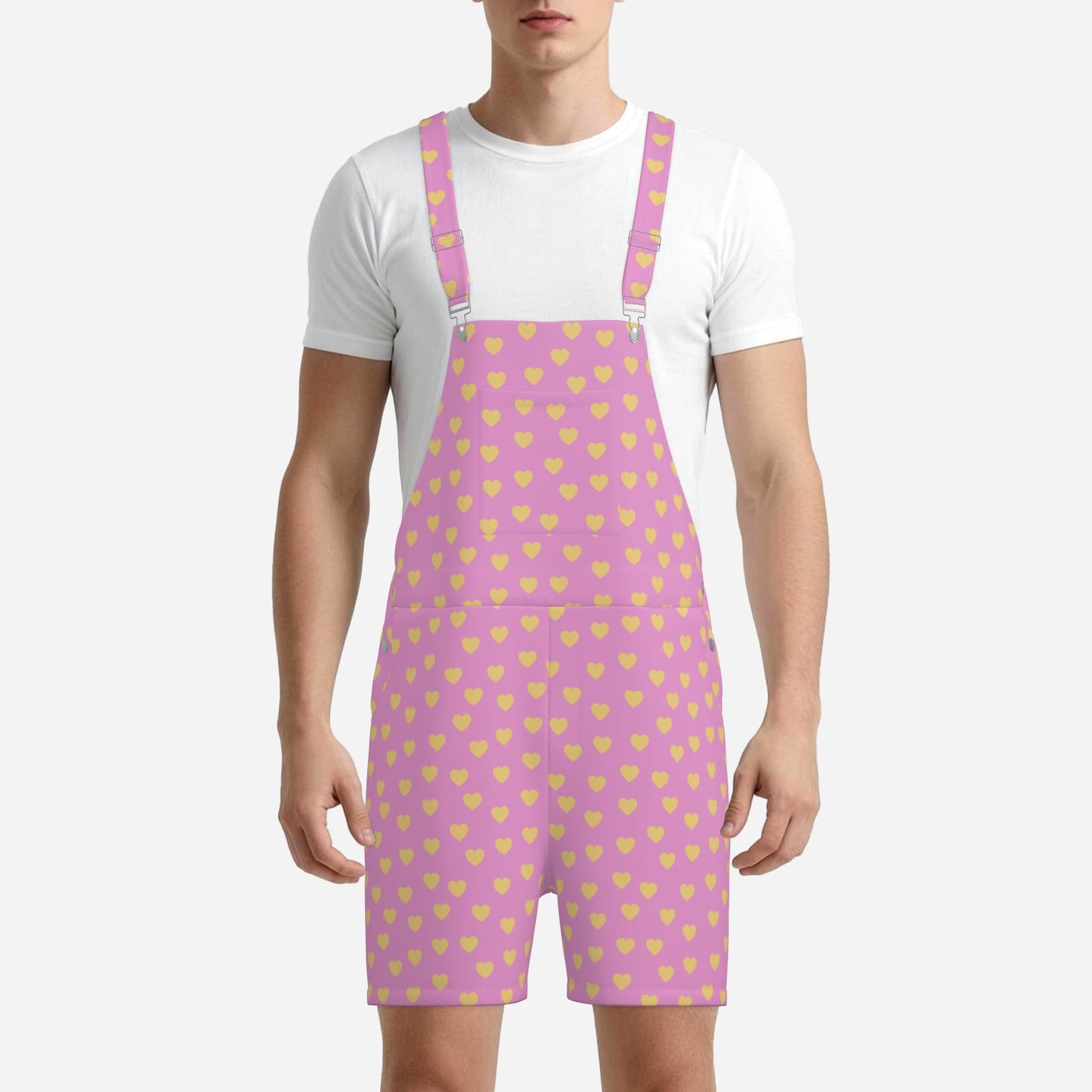 Person wearing a white t-shirt and pink overalls with yellow heart pattern on a white background