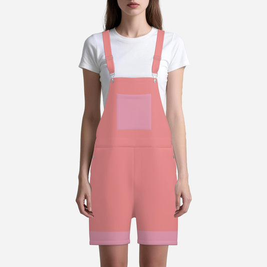 Person wearing a pink overall dress with a white t-shirt underneath on a white background