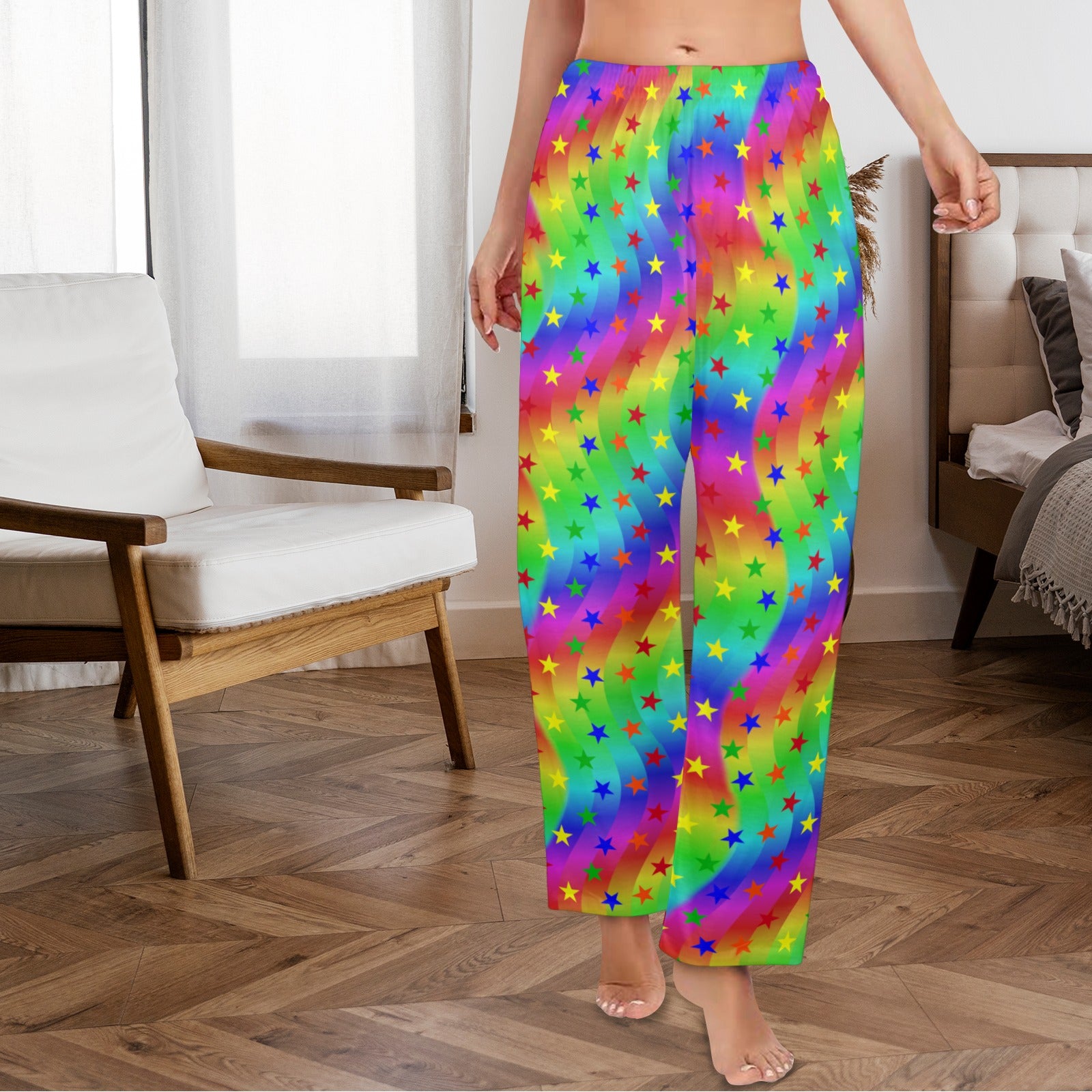 Person wearing colorful rainbow pants with star patterns in a room.