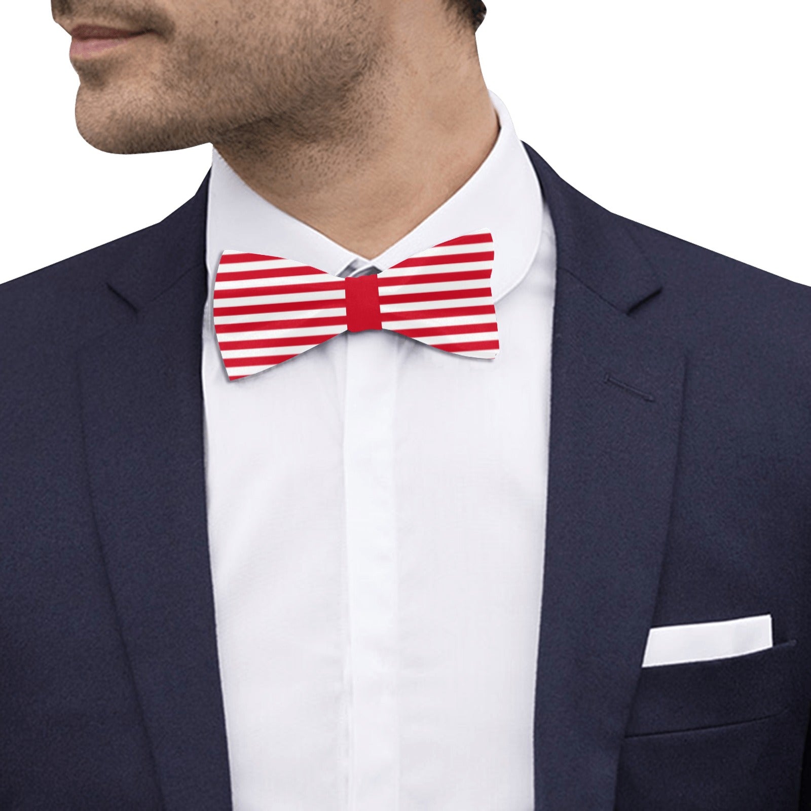 Man wearing a red and white striped bow tie with a navy suit and white shirt.