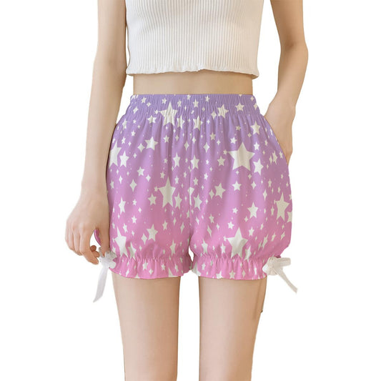 Purple pink ombre shorts with star pattern worn by a person on a white background