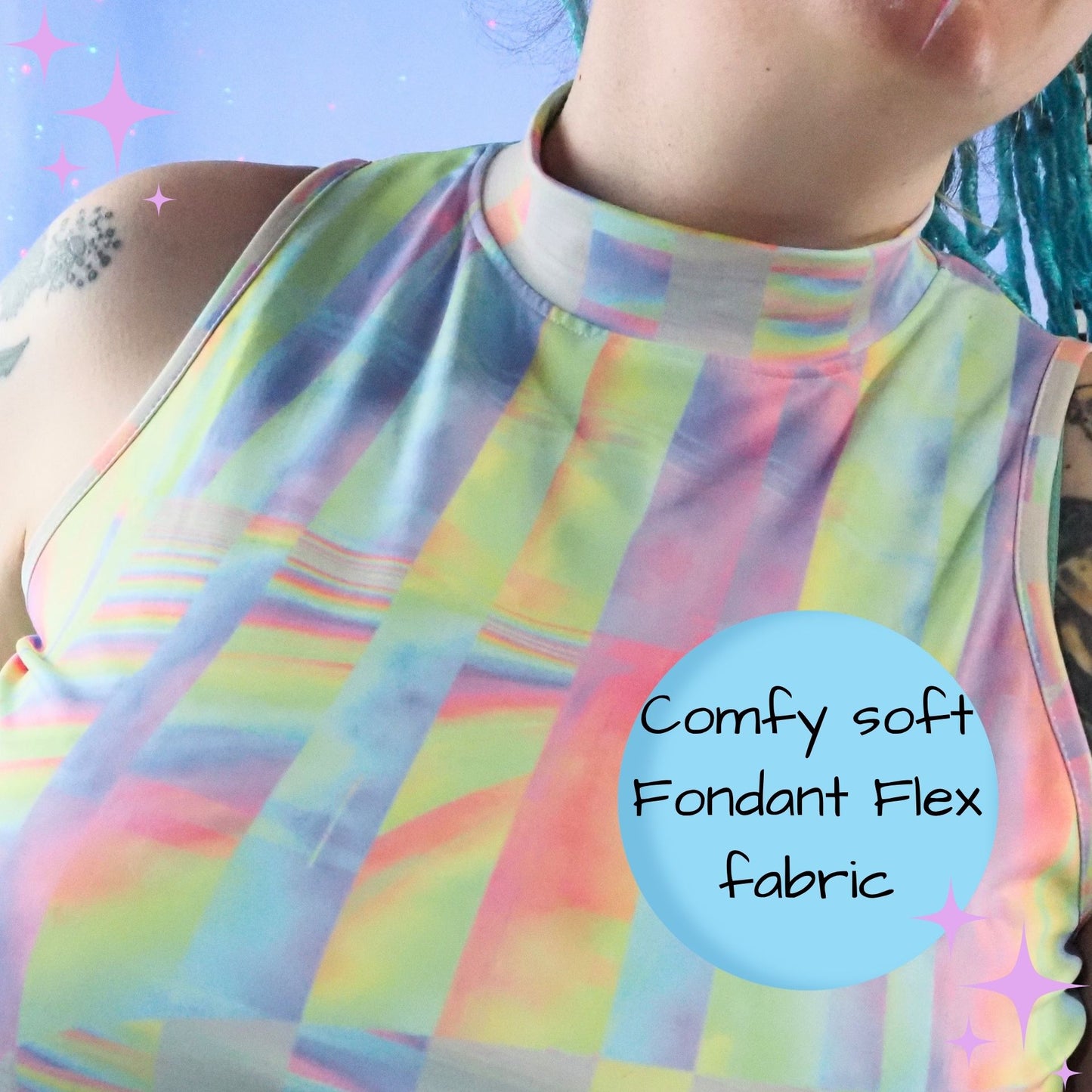 Close-up of a person wearing a sleeveless mock-neck top with a pastel rainbow striped and block pattern. A light blue circular text overlay reads 'Comfy soft Fondant Flex fabric' on the right side.