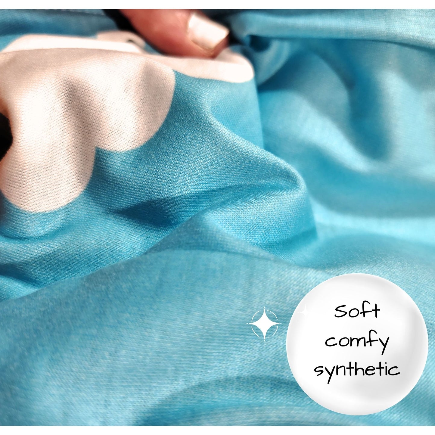 Close-up of blue fabric with a hand touching it, labeled 'soft comfy synthetic'.