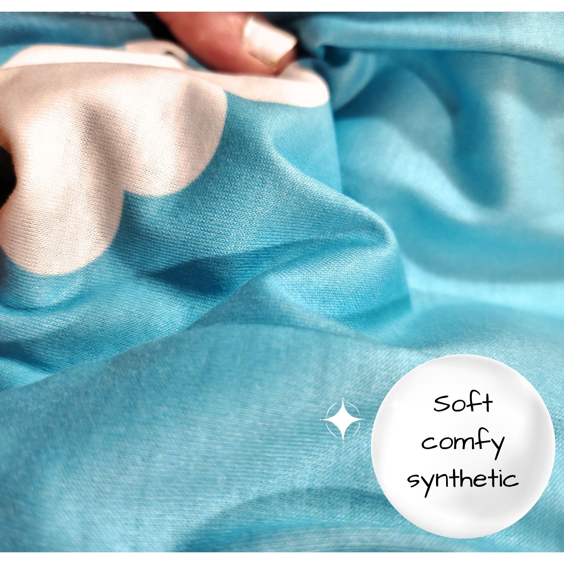 Close-up of blue fabric with a hand touching it, labeled 'soft comfy synthetic'.